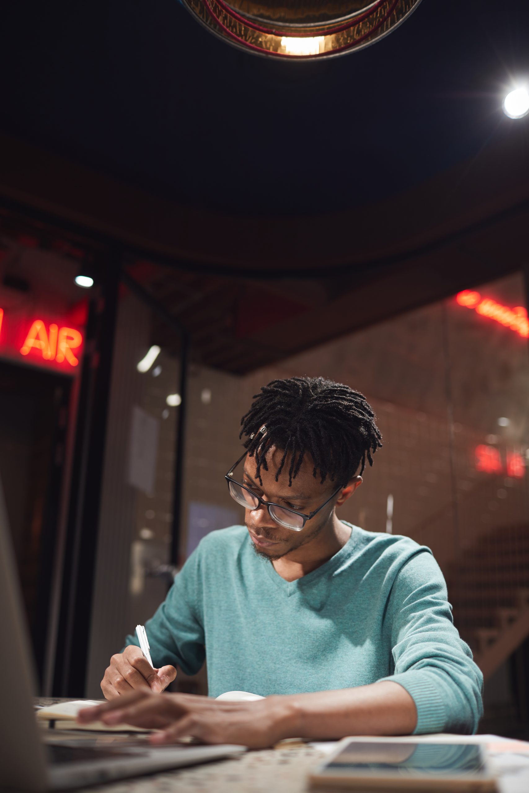 vertical portrait young african american man working late home dark office 1 scaled